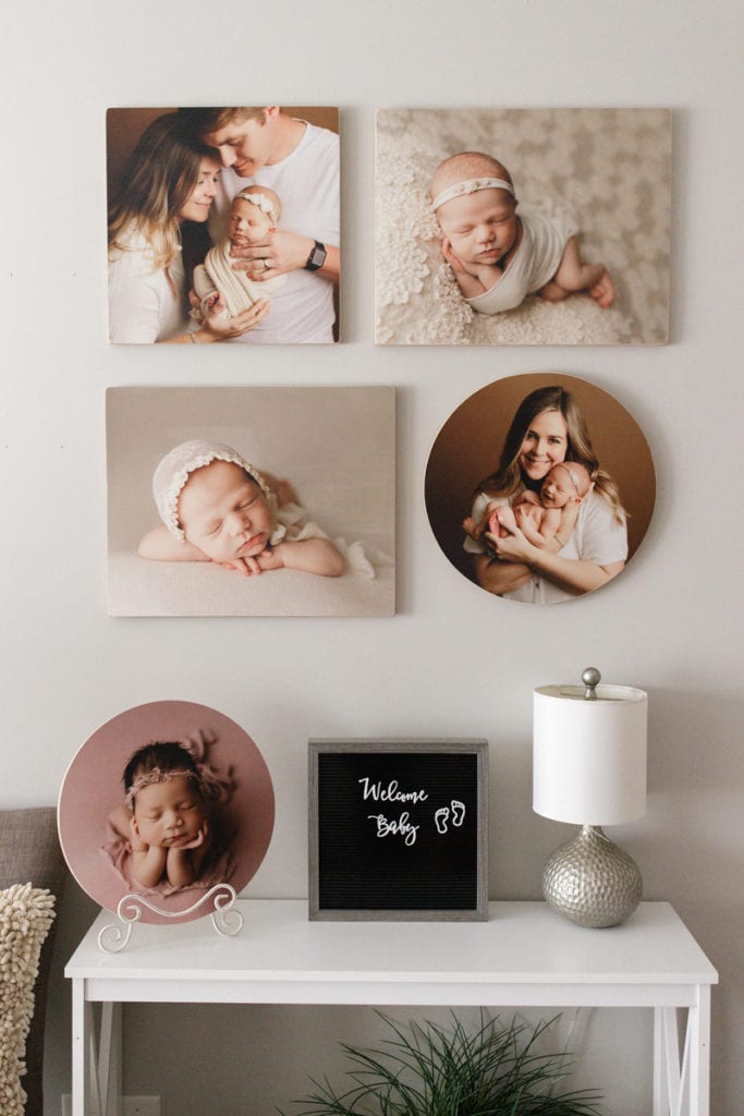Newborn Photographer, a nursery wall displays photos and frames of baby